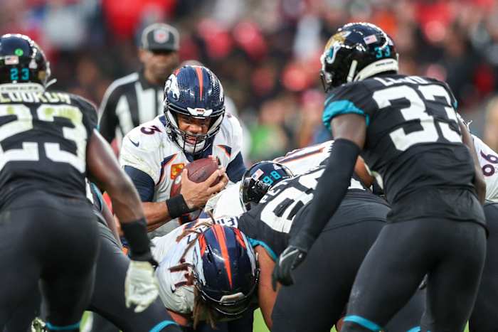 Denver Broncos quarterback Russell Wilson (3) stretches from first down against the Jacksonville Jaguars in the forth quarter during an NFL International Series game at Wembley Stadium.